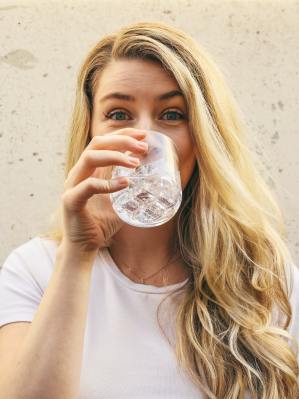 Young, healthy woman drinking a glass of water